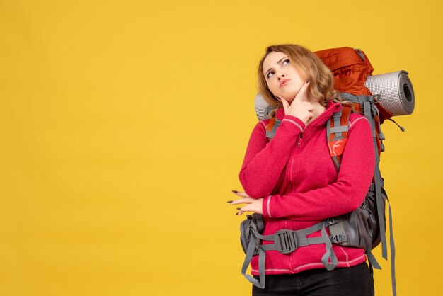 Vue de dessus de la jeune fille voyageuse rassemblant ses bagages et réfléchissant profondément