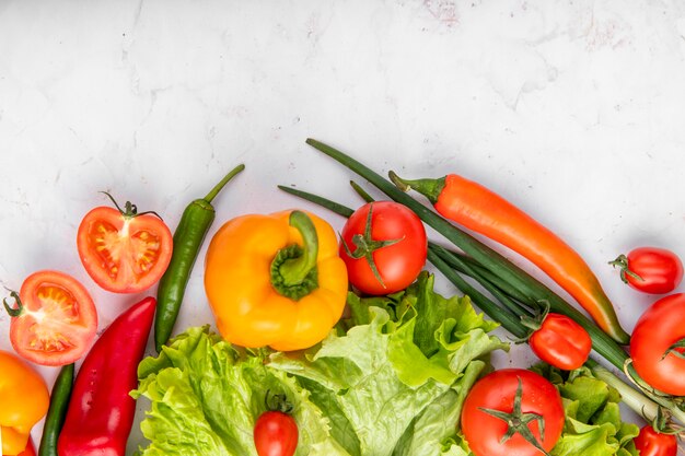 Vue De Dessus Des Légumes Comme Le Brocoli Et Les Oignons Verts De Poivrons Tomates Sur La Surface Blanche