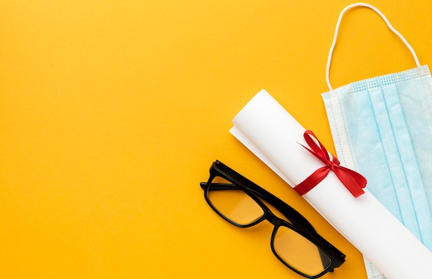 Vue de dessus des lunettes avec diplôme et masque médical