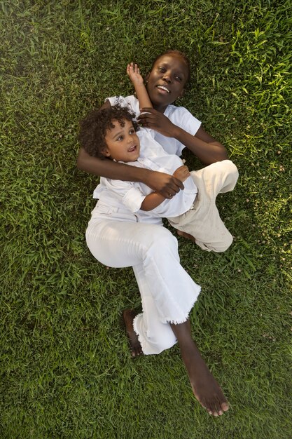 Vue de dessus mère et enfant allongés sur l'herbe