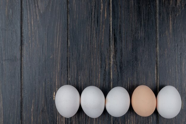 Vue de dessus des œufs de poule frais et sains sur un fond en bois avec espace copie