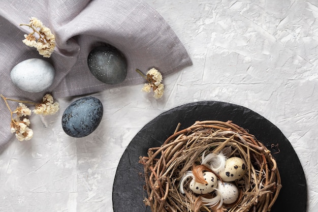 Vue de dessus des oeufs pour Pâques avec nid d'oiseau et tissu