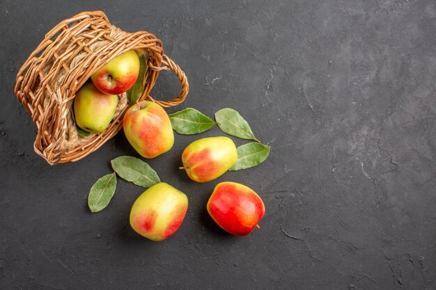 Vue de dessus pommes fraîches fruits mûrs à l'intérieur du panier sur la table grise fruits mûrs frais