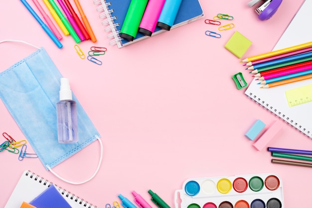 Photo gratuite vue de dessus de rentrée scolaire avec des crayons et un masque médical