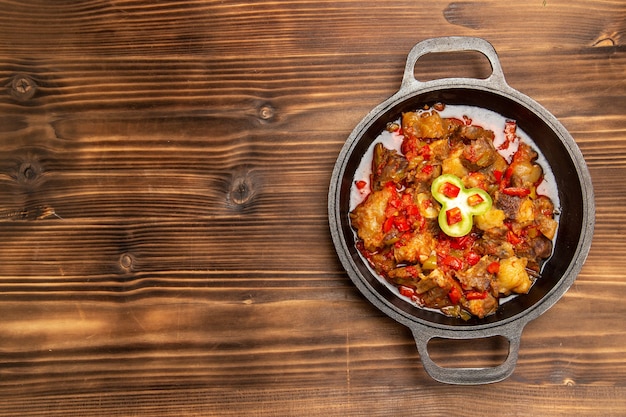 Vue de dessus repas de légumes cuits à l'intérieur de la casserole sur un bureau en bois