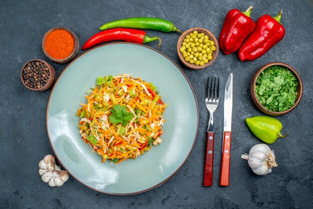 Vue de dessus de la salade de légumes avec des assaisonnements sur des aliments diététiques de salade de santé sombre