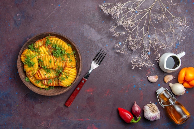 Photo gratuite vue de dessus de savoureuses pommes de terre cuites avec des légumes verts sur la surface sombre plat de repas du dîner cuisson des pommes de terre