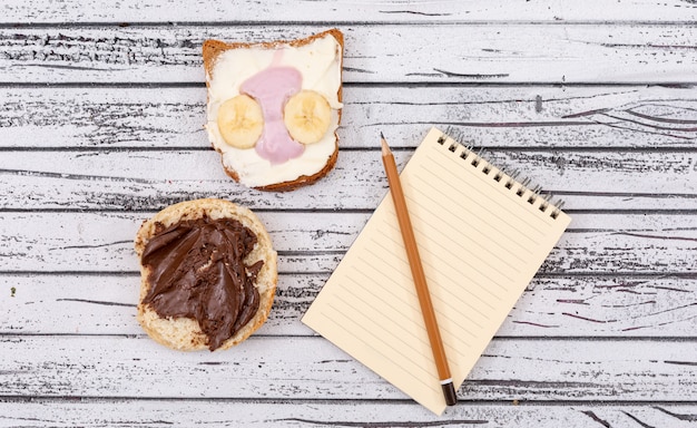 Vue de dessus des toasts avec copie espace sur ordinateur portable sur une surface en bois blanche horizontale