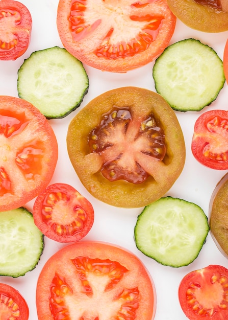 Photo gratuite vue de dessus de tomates biologiques avec des tranches de concombre