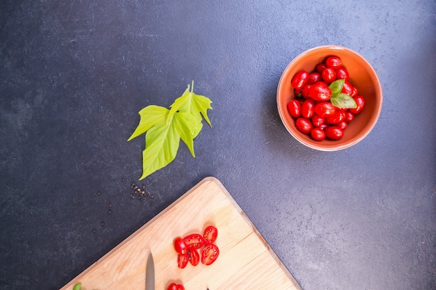 Vue de dessus des tomates cerises fraîches sur la planche de bois sur une table