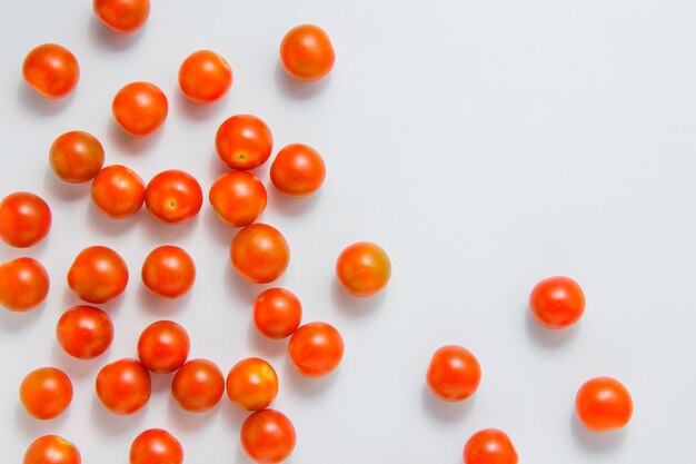 Vue de dessus des tomates sur fond blanc. espace horizontal pour le texte