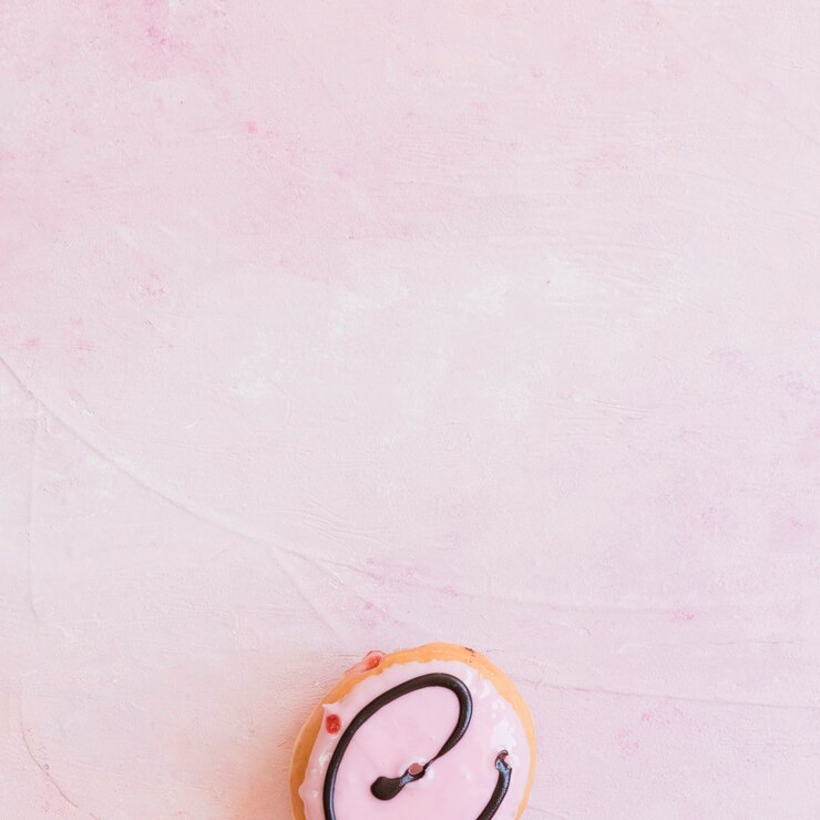 Photo gratuit vue élevée de beignets frais au bas du fond rose