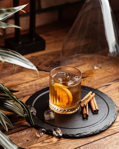 Une vue de face de l'alcool froid avec des glaçons sur le bureau en bois brun boire du vin d'alcool