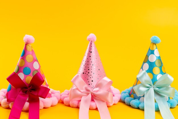 Une vue de face des bouchons d'anniversaire colorés avec des arcs sur le jaune, fête d'anniversaire