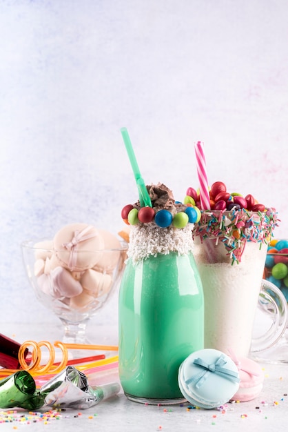 Vue de face des desserts avec des bonbons colorés et des pailles