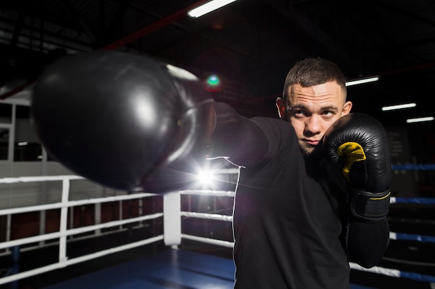 Vue de face du boxeur pratiquant dans des gants de protection