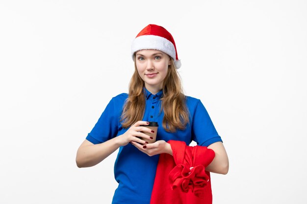 Vue de face du courrier féminin avec une tasse de café sur un mur blanc