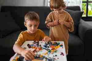 Photo gratuite vue de face des enfants jouant à l'intérieur