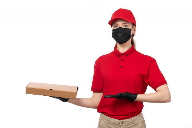 Une vue de face femme courrier en chemise rouge bonnet rouge gants noirs et masque noir tenant la boîte à pizza soulignant sur blanc