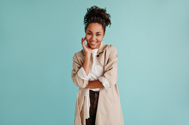 Vue de face d'une femme curieuse en trench-coat