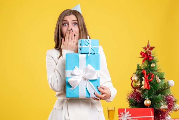 Vue de face femme médecin tenant des cadeaux de Noël