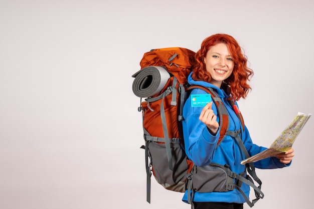 Vue de face femme touriste en voyage en montagne avec sac à dos et carte