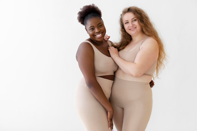 Vue de face des femmes confiantes posant tout en portant un body shaper