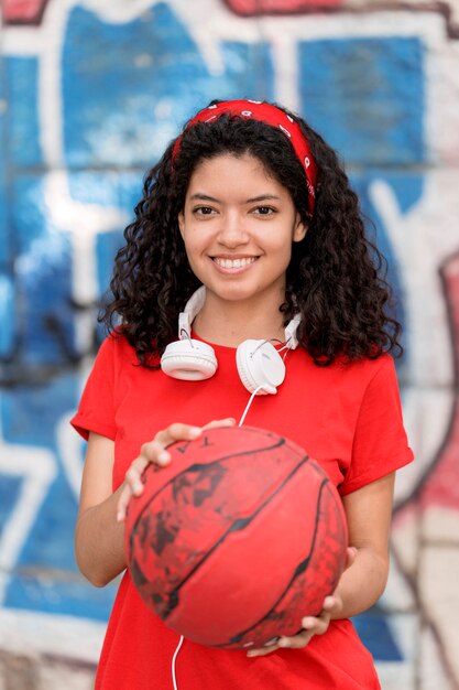 Vue de face fille heureuse tenant le ballon