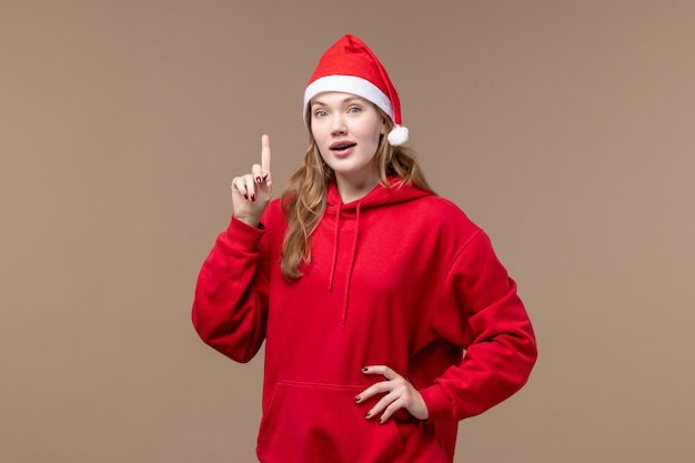 Vue de face fille de Noël sur fond marron vacances nouvel an Noël