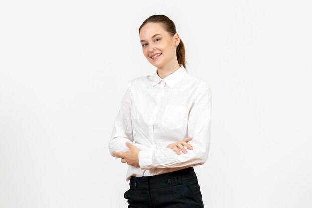 Vue de face jeune femme en blouse blanche avec une expression souriante sur fond blanc modèle de sentiment d'émotion de bureau d'emploi féminin