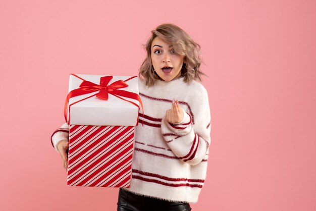 Vue de face jeune femme avec cadeau de Noël