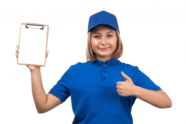 Une vue de face jeune femme courrier en uniforme bleu tenant le bloc-notes pour les signatures