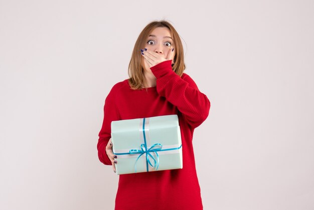 Vue de face jeune femme debout avec cadeau de Noël