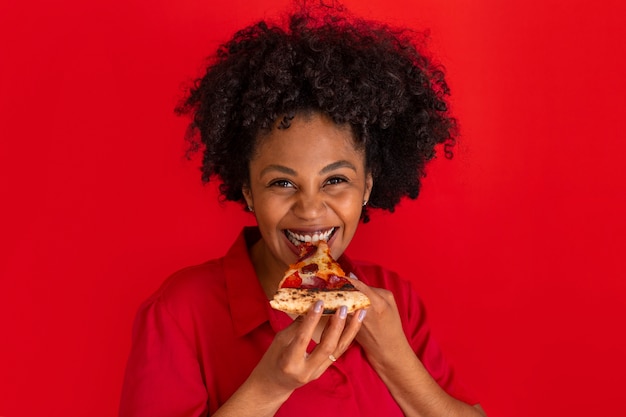 Photo gratuite vue de face jeune femme mangeant une délicieuse pizza