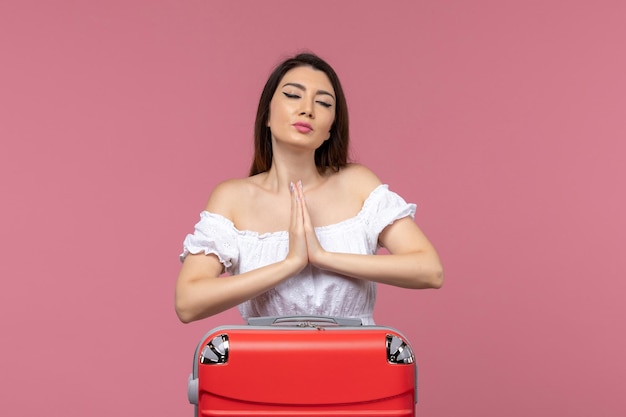 Vue de face jeune femme prépare pour les vacances avec son sac sur le fond rose à l'étranger voyage en mer voyage voyage voyage