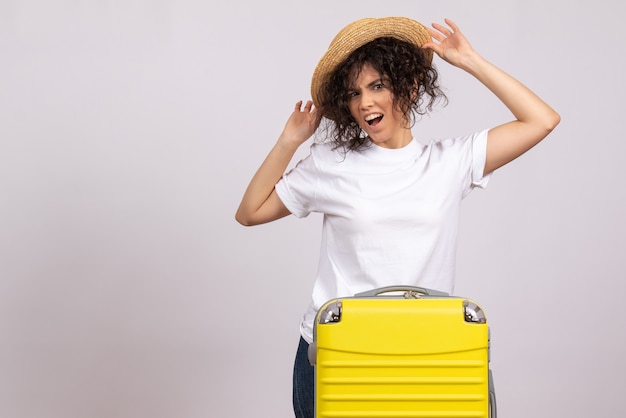 Photo gratuite vue de face jeune femme avec sac jaune se préparant au voyage sur fond blanc vacances touristiques voyage couleur reste vol