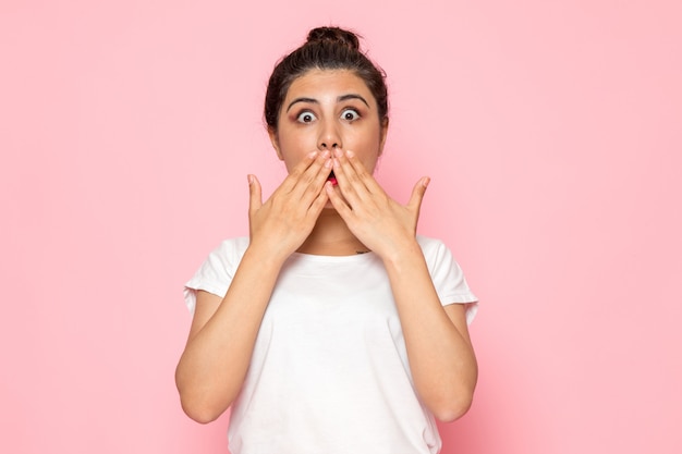 Une vue de face jeune femme en t-shirt blanc avec expression choquée dame geste émotion