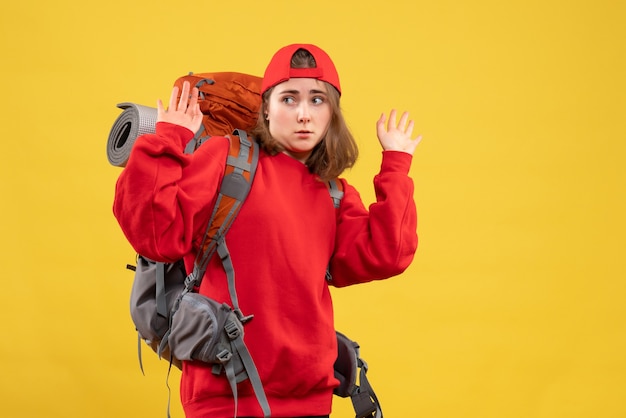 Vue de face jeune femme voyageur avec sac à dos levant les mains