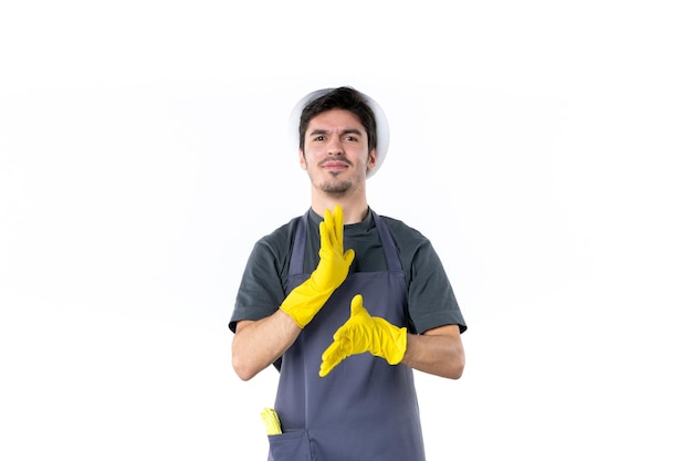 Vue de face jeune homme en gants jaunes sur fond blanc fleur plante travail jardin herbe arbre jardinier vert