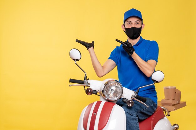 Vue de face jeune homme en uniforme bleu et masque sur fond jaune