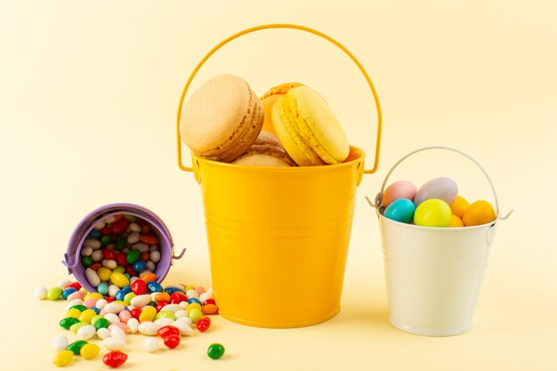 Une vue de face macarons français colorés à l'intérieur du panier avec des bonbons cuire