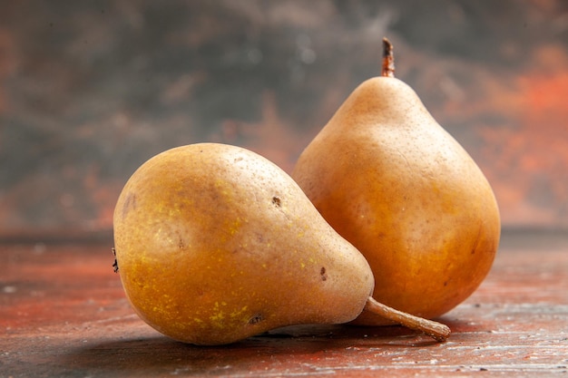 Photo gratuite vue de face des poires douces sur le fond sombre