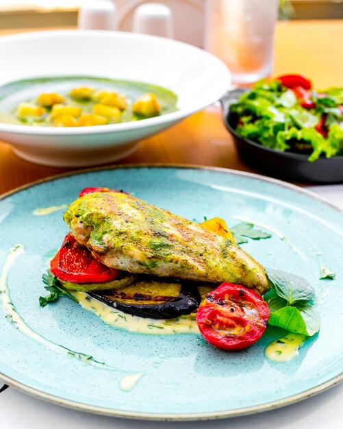 Vue de face Poitrine de poulet grillée avec sauce et légumes grillés