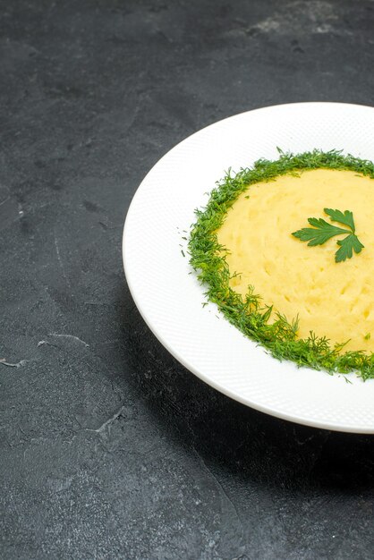 Vue de face en purée de pommes de terre avec des verts à l'intérieur de la plaque sur l'espace gris