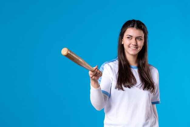 Vue de face souriante jeune femme avec batte de baseball