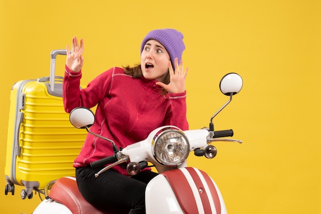 Vue de face terrifiée jeune fille sur un cyclomoteur