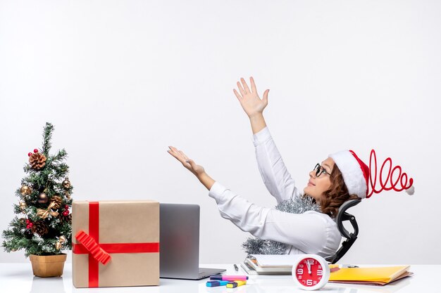 Vue de face travailleuse assise devant son lieu de travail souriant travail bureau travail entreprise noël