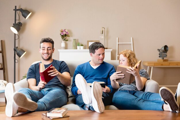 Vue de face de trois amis tenant des livres