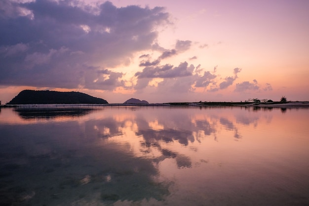 Vue fascinante du ciel se reflétant dans l'eau pendant le coucher du soleil