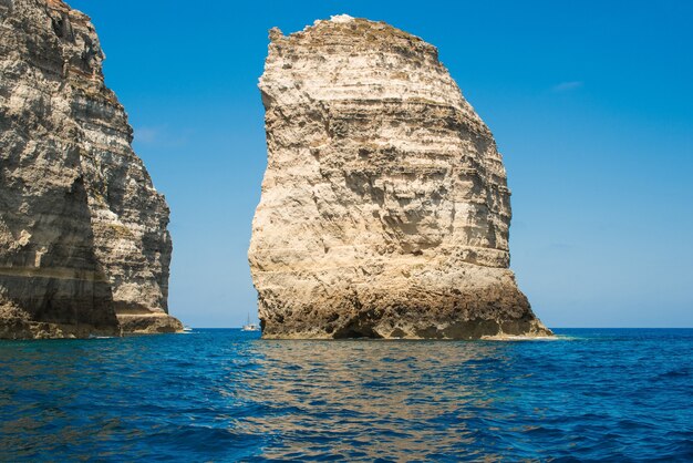 Vue imprenable sur d'immenses formations rocheuses dans une eau de mer calme